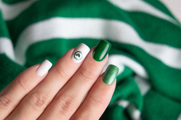 istock Female hands with green manicure nails 2149017180