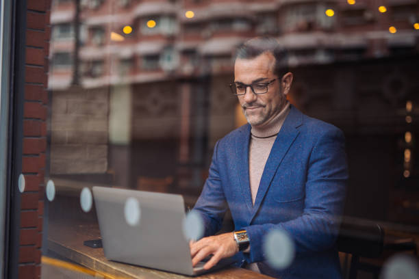 istock Modern man working on a laptop in cafe 2149017274