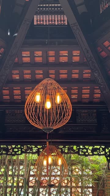 Decorative bamboo lamps hanging from the roof of traditional Indonesian wood house