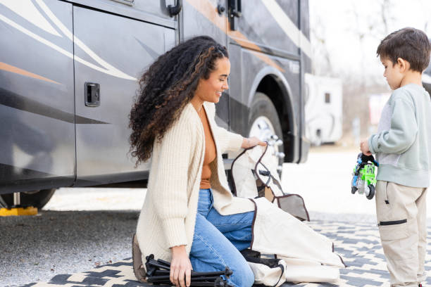 istock Young boy asks his mom questions while she puts away camping supplies 2149017602