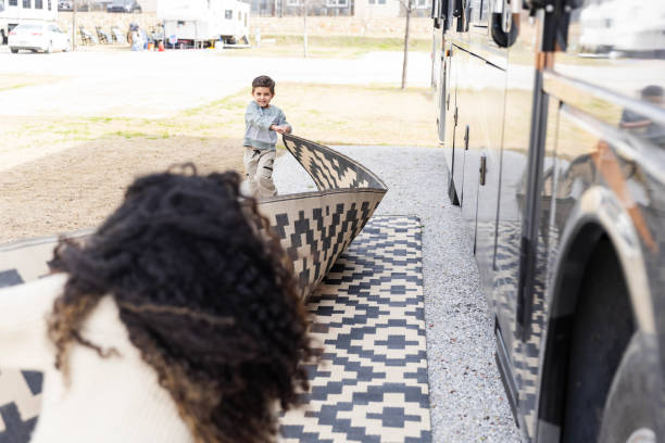 Mother and son work together to put the outdoor rug on the floor