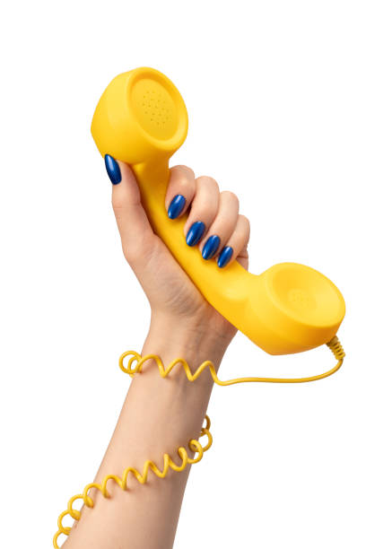istock Yellow handset in woman hand isolated on white. Copy space. 2149019622