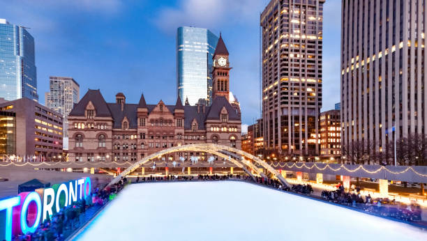 Toronto winter ice skating rink at Nathan Phillips Square with old City hall in background