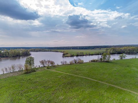 Drone view on  spring coming to Russsia: Moskva river near village Zhakharkovo (ther work electronic warfare) . So can suggest that rich and influential people live here in some cottages in forest. main course come from left , old course from right and river move water to Moscow in left lower corner