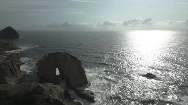 Flying Paraglider Over Cape Kiwanda In Pacific City, Oregon, United States At Sunset - Aerial Drone Shot