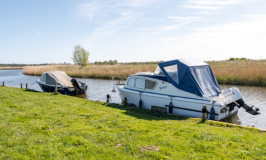Upton, Norfolk, UK  April 14 2024. Leisure boats and motor boats moored in Upton Dyke on the Bure River, Norfolk Broads