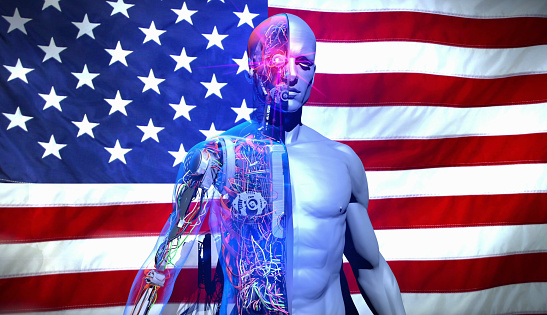 An artificially intelligent, half-robot, half-human superhero stands at attention in front of the American flag. Video referring to technology leader America. / You can see the animation movie of this image from my iStock video portfolio. Video number: 2148825664