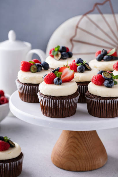 istock Chocolate cupcakes with vanilla frosting and fresh berries 2149028235