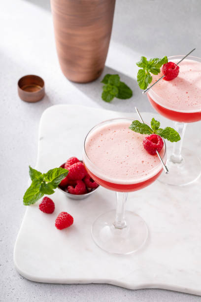 istock Raspberry martini in coupe glasses garnished with fresh raspberries and mint 2149028256