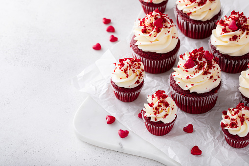 Red velvet cupcakes with cream cheese frosting and red velvet crumbs for Valentines day