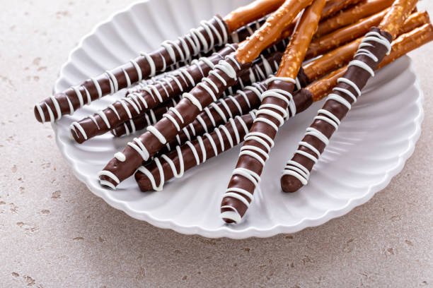 istock Chocolate dipped pretzel rods on a plate 2149028341