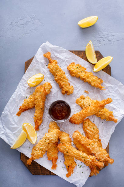 istock Cooked tempura shrimp on a serving board with dipping sauce 2149028344