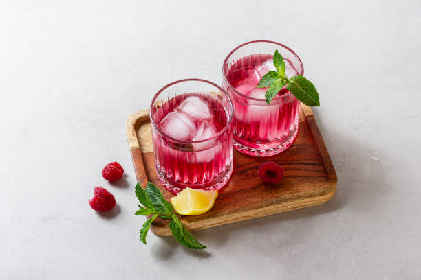 istock Raspberry cocktail with ice in a glass on a light background 2149029978