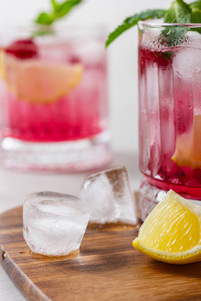 istock Raspberry cocktail with ice in a glass on a light background 2149029979
