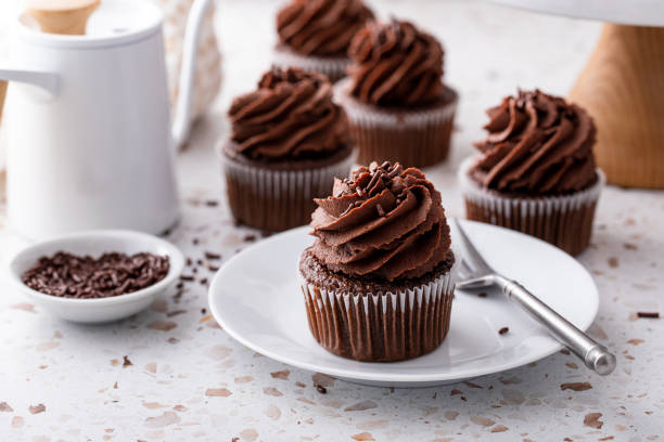 istock Chocolate cupcakes topped with whipped chocolate ganache 2149030059