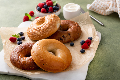 Variety of bagels freshly baked for breakfast ready to eat, plain, sesame seed and cinnamon raisin bagels