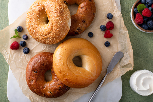 Variety of bagels freshly baked for breakfast ready to eat, plain, sesame seed and cinnamon raisin bagels