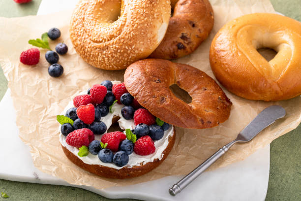 istock Cinnamon raisin bagel topped with cream cheese and fresh berries 2149030075