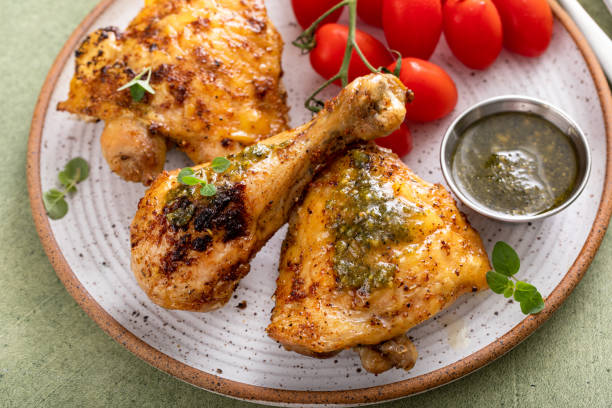 istock Roasted chicken thighs and drumsticks served with pesto sauce 2149030100