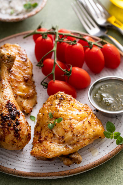istock Roasted chicken thighs and drumsticks served with pesto sauce 2149030115