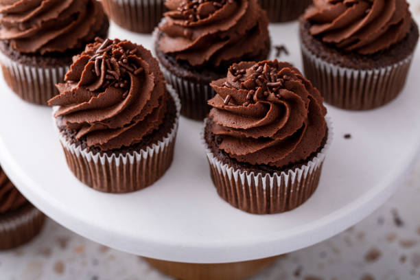 istock Chocolate cupcakes topped with whipped chocolate ganache 2149030184