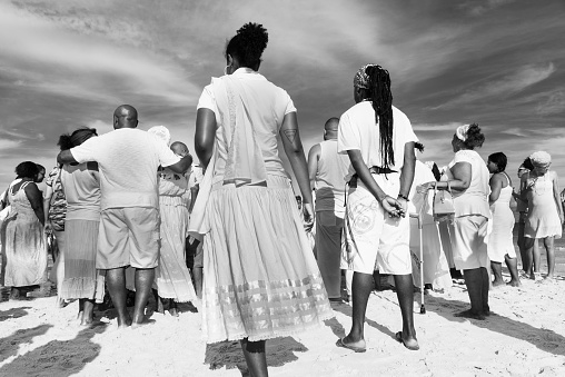 Santo Amaro, Bahia, Brazil - May 19, 2019: Umbanda supporters are seen dancing during a tribute to iemanja on Itapema beach in the city of Santo Amaro, Bahia.