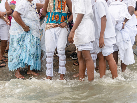 Santo Amaro, Bahia, Brazil - May 19, 2019: Members of Candomble are seen participating in the tribute to iemanja on Itapema beach in the city of Santo Amaro, Bahia.