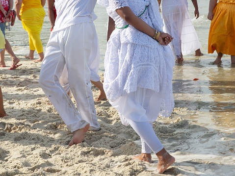Santo Amaro, Bahia, Brazil - May 19, 2019: Umbanda supporters are seen dancing during a tribute to iemanja on Itapema beach in the city of Santo Amaro, Bahia.