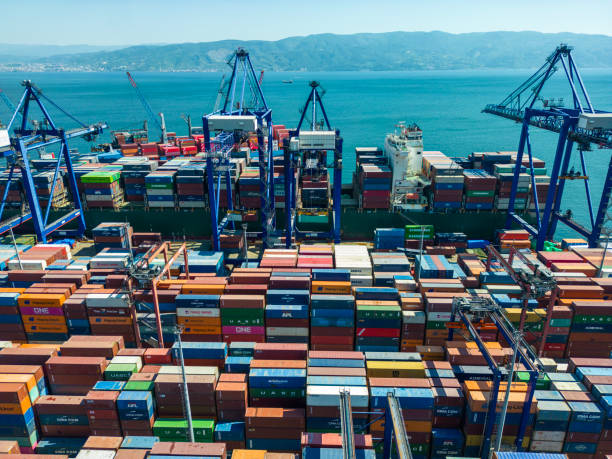 istock High angle view of  container cargo freight ship with working crane bridge  at import harbor, Kocaeli, Turkey 2149033914