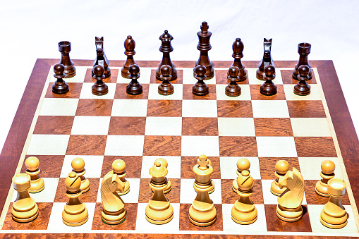 Old wooden chess board on white