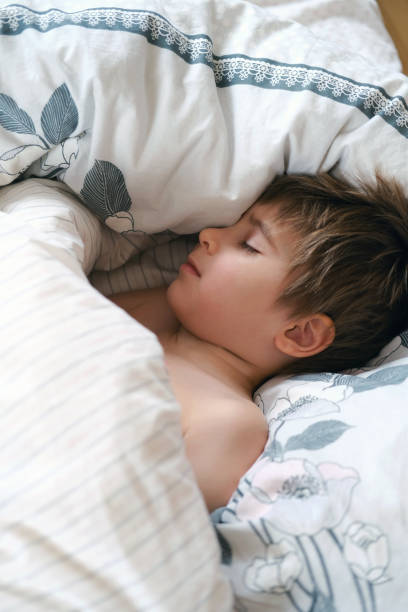istock Cute little toddler boy is sleeping with beige plaid at home. Bedtime, napping 2149034586