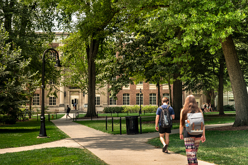 State College, Pennsylvania, USA - August 4, 2023:  Students walk along the paths of the University Park to the classroom lectures on the campus of Penn State university