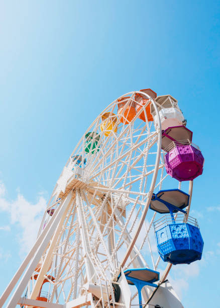istock White ferris with colorful cabs wheel spinning amusement park ride 2149037045