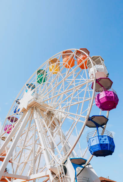 istock White ferris with colorful cabs wheel spinning amusement park ride 2149037093
