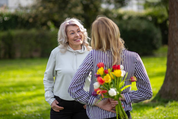 istock Daughter hiding tulips behind back 2149037172