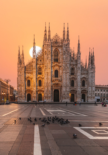 At sunset, the Milan Cathedral or Duomo di Milano, one of the largest churches in the world, is a stunning sight on Piazza Duomo Square in the heart of Milano Italy