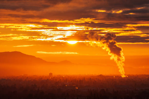 Industrial steam billowing into glowing sunrise above the San Fernando Valley in Los Angeles California.