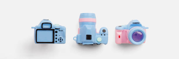 Colorful toy camera on pastel color background, top view