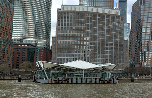 brookfield place ferry terminal on the hudson river in downtown manhattan with nyc skyline skycraper buildings in the background (boat transport stop) new jersey access new york city waterway harbor