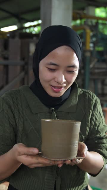 muslim woman making pottery wheel in art studio