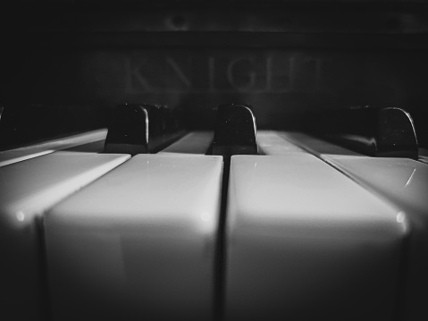 Closeup of piano keys in black and white