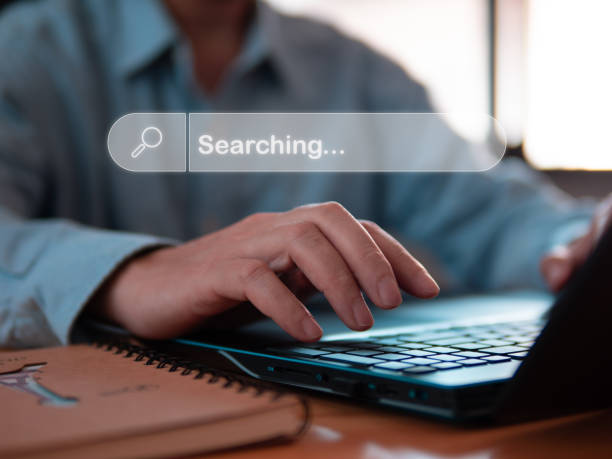 istock Close-up person typing or searching information via internet technology in laptops on wood table in room or office. 2149043805