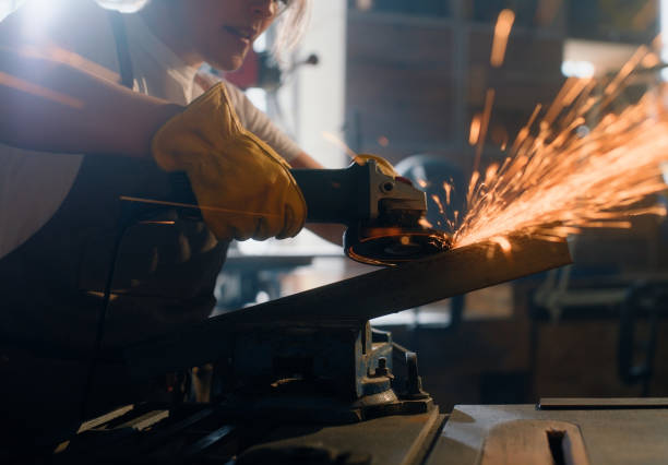 istock Welder, person hands and iron cutting blade with spark for infrastructure production or remodeling. Machine, blacksmith and garage with project and chop shop with factory and metal worker in workshop 2149044034