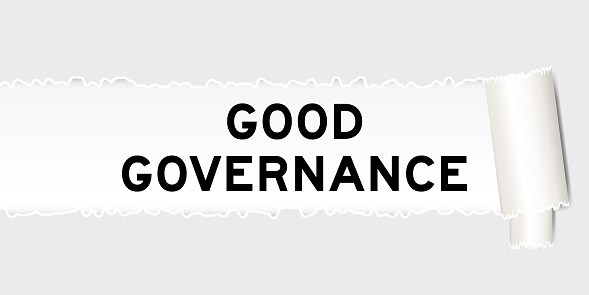 Ripped gray paper background that have word good governance under torn part