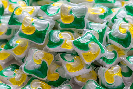 Dishwasher detergent capsules and or laundry soap close up background