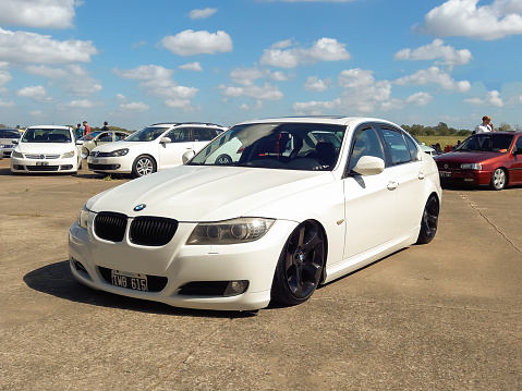 Morón, Argentina - Apr 7, 2024: Old white 2000s BMW 3 Series E90 sedan at a classic car show in an airfield. Copy space