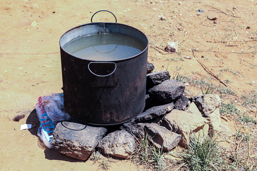Heating water on rocks inside a camp for Syrian refugees in Qibb Ilyas (Qab Ilyas), Lebanon.