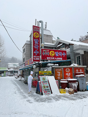 Seoul, Korea - December 21th 2022, Its a winter snow day morning at Dobongsan Mountain Entrance Food Street, Bukhansan Mountain National Park in Seoul Korea. 서울 도봉산 칼국수집