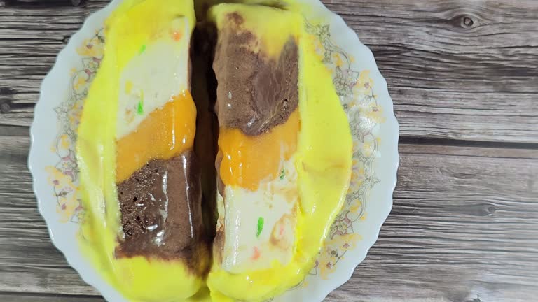 Gelato layer with New Zealand butter, whipped cream inside, and layers of cantaloupe, chocolate and mango, frozen dessert of ice cream with mixed flavors of chocolate, vanilla, mango and cantaloupe
