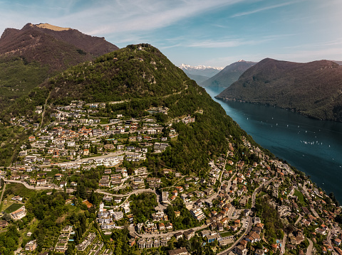 Aerial view of Beautiful Lugano lake and Lugano City neighborhood on a hill in Southern Switzerland, Ticino Canton.